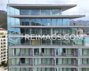 Glass balcony and panoramic windows with a sea view - Hotel apartments for sale in Becici, Montenegro. Elite accommodations on the Adriatic coast.