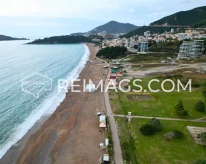 Long sandy beach in Becici, clean coastline, surrounded by mountains - Ideal real estate location in Montenegro.
